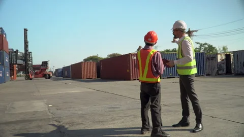 Senior asian engineer talking with  Caucasian worker control forklift and c.. Stock Footage 248363326