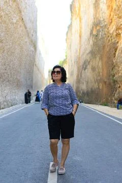 Senior Asian Lady Posing Casually in a Canyon Passage 스톡 사진