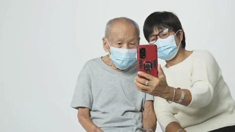 Senior Asian man doing a video call via mobile phone to his relative. Video stock 155678870