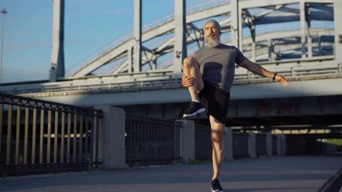 Senior athlete warming up before running Stock Footage 135563189