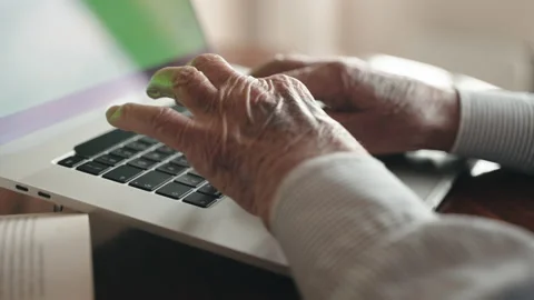 Senior author preparing book edition typing project on computer keyboard Stock Footage 170463779