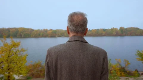 Senior back view posing on riverside in fall Stock Footage 146447564