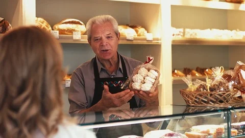 Senior Baker Helping His Customer at the Bakery Stock Footage 72170849