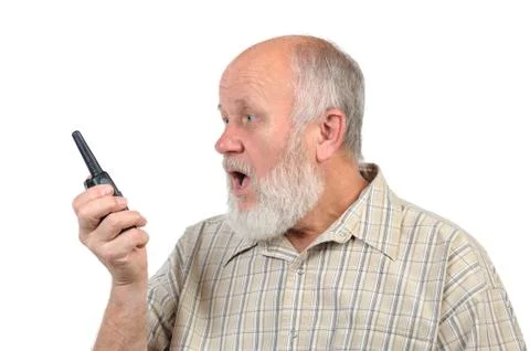 Senior bald man talking using walkie-talkie, with mouth open Photos