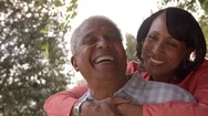 Senior Black Couple Piggyback In Garden, Close Up Stock Footage