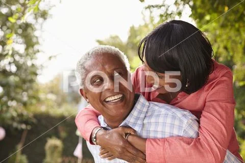 Senior black couple piggyback, looking at each other Stock Photos