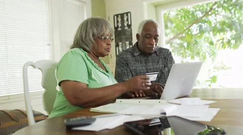 Senior black couple using laptop to pay bills Video stock 51217529