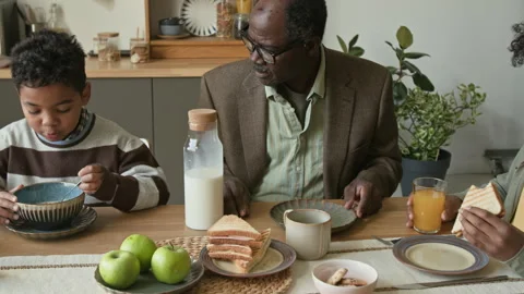 Senior Black Man Caring for Grandsons during Healthy Breakfast at Dining Table Stock Footage 322527072