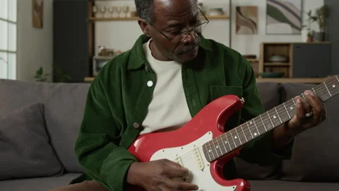 Senior Black Man Learning to Play Guitar Stock Footage 333424049