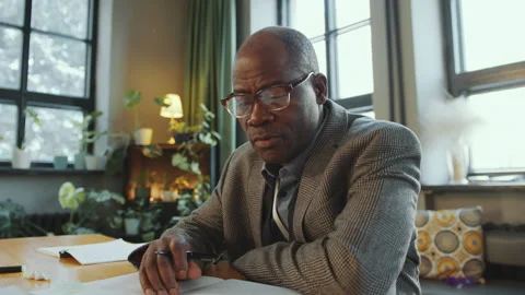 Senior Black Teacher Talking at Camera as Giving Online Lesson on Video Call Stock Footage 274618457