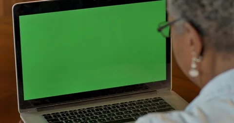 Senior black woman looking at a green screen chroma key computer screen Stock Footage