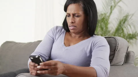 Senior black woman upset using smartphone Stock Footage