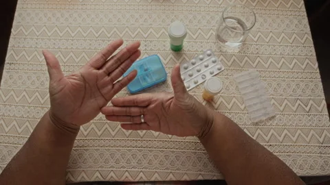 Senior Black Womans Hands Showing Empty Palms near Pill Organizer Vídeo Stock 337579725