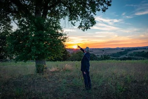 Senior botanist talking with the magic tree at sunset #05 Stock Photos