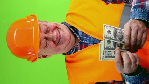 Senior builder in hardhat counts money from construction works and dancing. Stock Footage 252294069