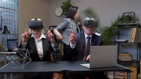 Senior business colleagues using virtual reality 3D app headset helmet doing Stock Footage 151995384