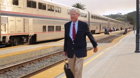 Senior Business Man Pulls Suitcase in Rush on Train Platform Stock Footage 32348974