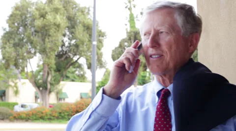 Senior Business Man Talks on Cell Phone Suit Slung over Shoulder Close Up Stock Footage 32233749
