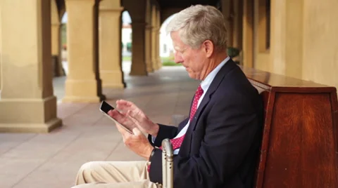Senior Business Man Using Tablet Computer on Bench at Station Stock Footage 31069096