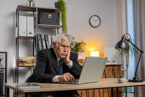 Senior businessman having software problems with laptop seeing error Stock Photos