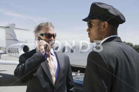 Senior Businessman Outside Private Jet On Call By Chauffeur Stock Photos