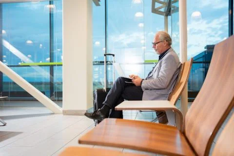 Senior Businessman Using Laptop While Waiting For Flight 写真素材