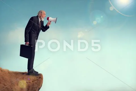 Senior businessman yelling through a loudhailer Stock Photos