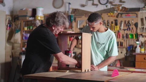 Senior Carpenter and Young Apprentice Collaborating in Carpentry Workshop Video stock 246767185