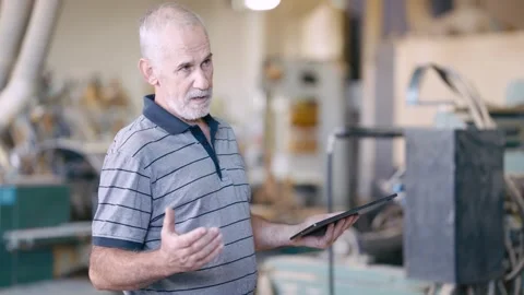 Senior carpenter explaining work process in his workshop Stock Footage 347003854