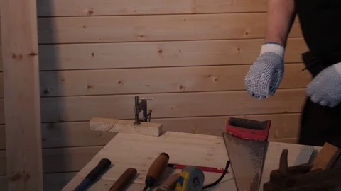 Senior carpenter sawing board Stock Footage 77214027