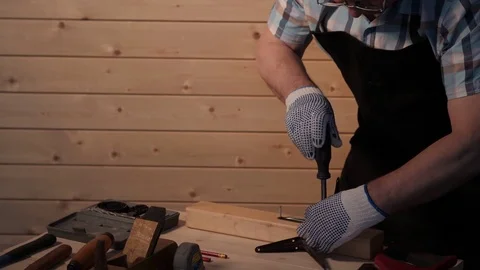Senior carpenter tighten the screw Stock Footage 77214336