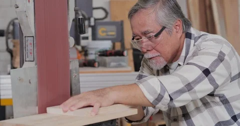Senior carpenter using some power tools for her work in a woodshop. Stock Footage 119005902