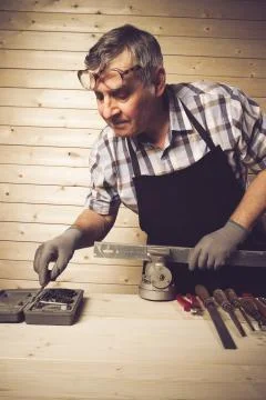 Senior carpenter working in his workshop Stock Photos