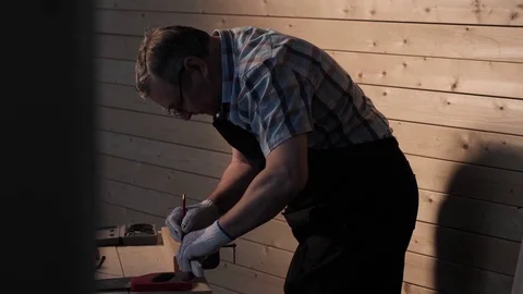Senior carpenter working with straightedge Stock Footage 77109313
