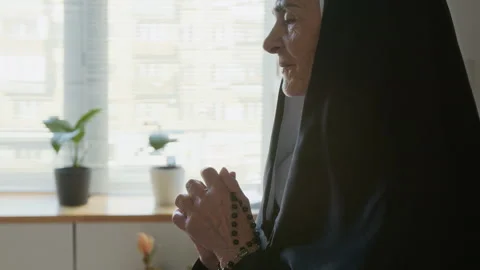 Senior Catholic Nun Praying in Classroom Stock Footage 311804932