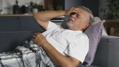 Senior caucasian lying at the sofa with cold and flu Stock Footage 218718484