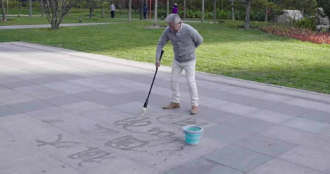 Senior Chinese man practicing calligraphy in the park,4K Stock Footage 227184432