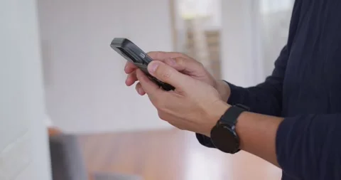 Senior Chinese man tapping keypad phone at home using right thumb, watch Stock Footage 337745334