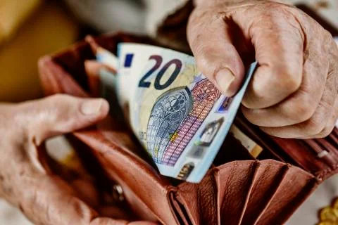 Senior citizen pulls a 20 euro note from her wallet Germany Europe Stock Photos