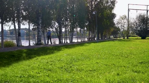 Senior citizen walking by the park Stock Footage 249899504