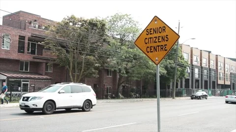 Senior citizens centre yellow diamond sign in black writing with black border Stock Footage 247749416
