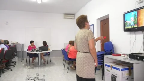 Senior citizens learning to use computers and new technologies in a classroom Stock Footage 333282752