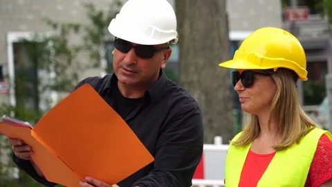 Senior construction site manager and apprentice Stock Footage 113901618