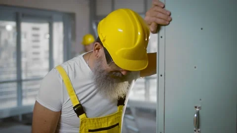 Senior construction worker sick and coughing in renovating apartment Stock Footage 145969572