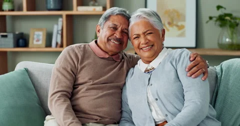 Senior, couple and face on sofa with hug for love, commitment and safety with Video stock 270693998