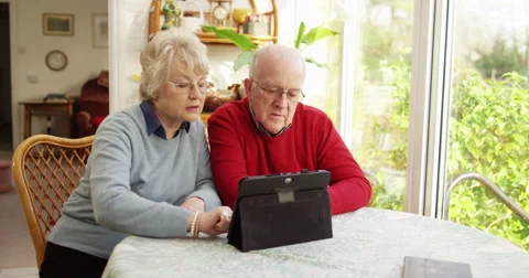 Senior couple browsing the internet on a digital tablet. Shot on RED Epic. Stock Footage 58896794