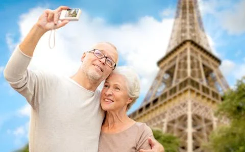 Senior couple with camera over eiffel tower Fotos Stock