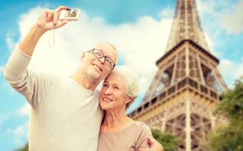 Senior couple with camera over eiffel tower Fotos Stock