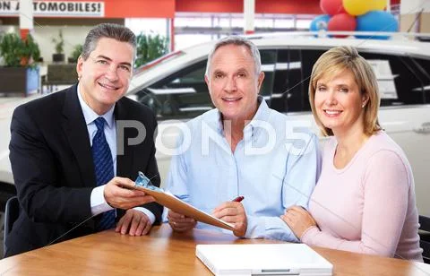 Senior couple with car dealer agent. Stock Photos