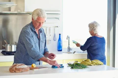 Senior couple cleaning the kitchen Stock Photos
